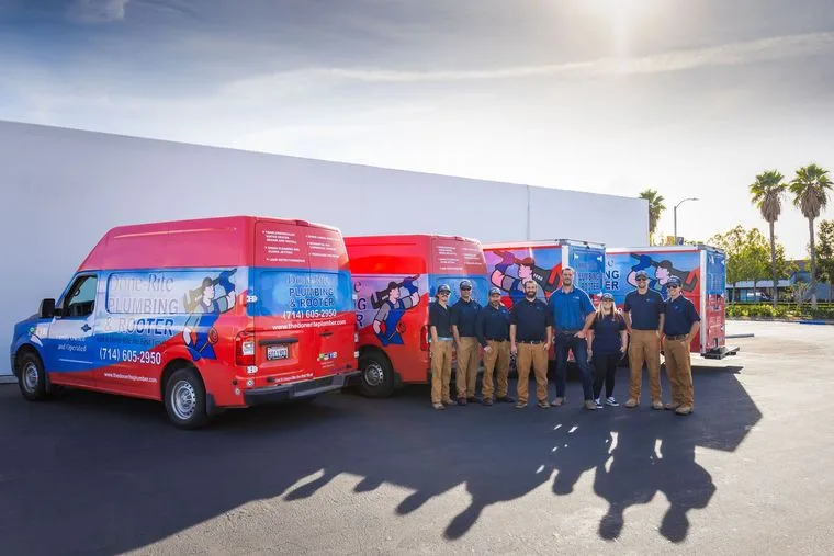 Done-Rite Plumbing & Rooter team lined up beside their service vans